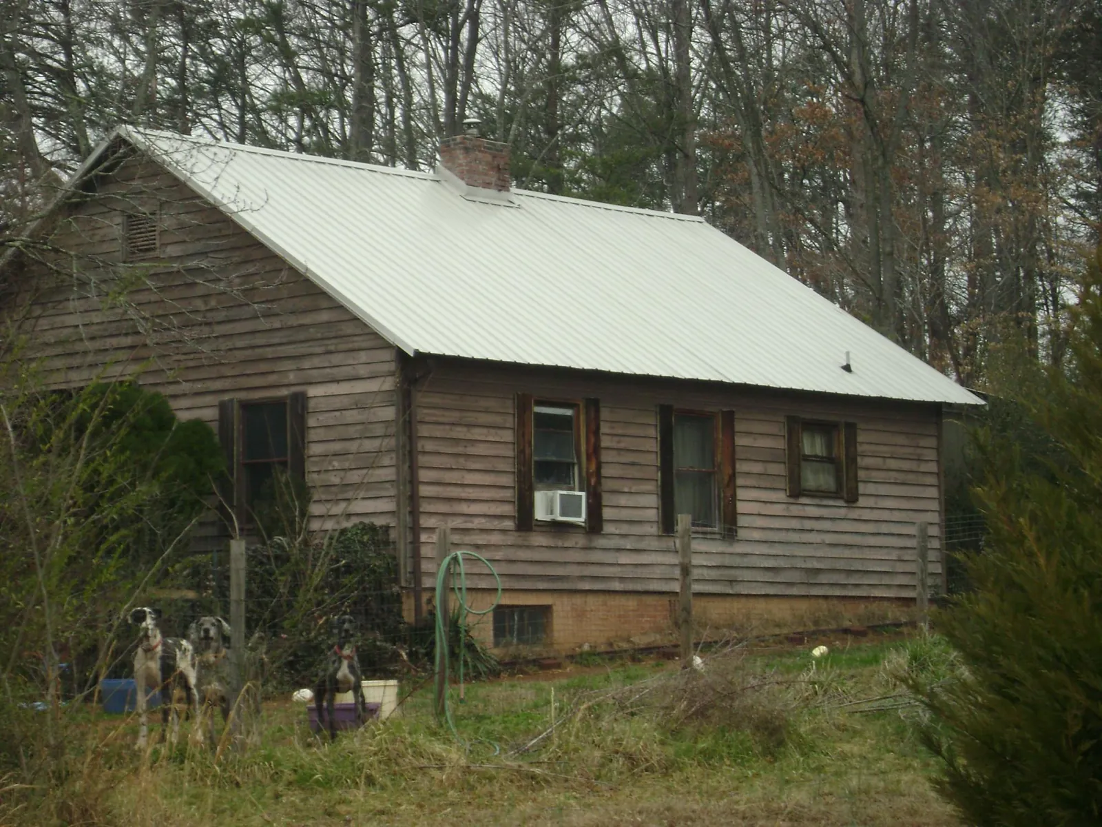 White metal roof on an old wood sided farmhouse, from a Metal Roof Installation job in Fiskdale